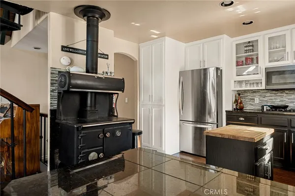 a kitchen with stainless steel appliances a refrigerator and a stove