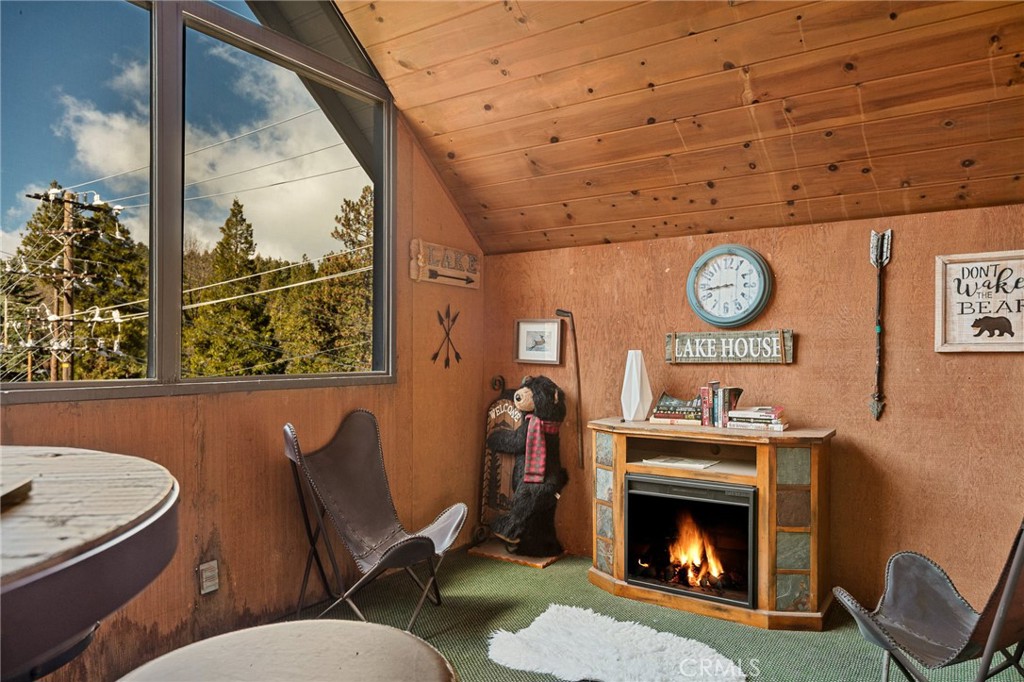 1055 Meadow Brook Road Lake Arrowhead, CA 92352 - Photo 7 of 27 a living room with furniture and a fireplace