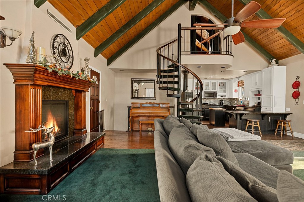 1055 Meadow Brook Road Lake Arrowhead, CA 92352 - Photo 9 of 27 a living room with furniture a flat screen tv and kitchen view