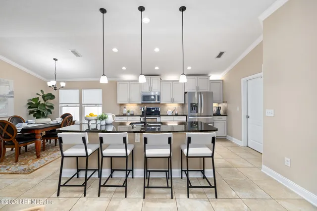a bathroom with a granite countertop sink a toilet and a mirror