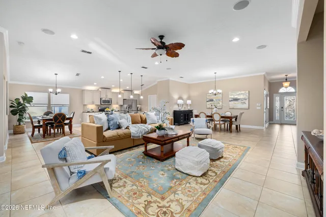 a kitchen with stainless steel appliances granite countertop a stove a sink a kitchen island with a dining table and chairs