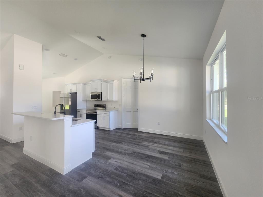 9483 Southwest 121st Terrace Dunnellon, FL 34432 - Photo 15 of 42 a view of a kitchen with microwave and wooden floor