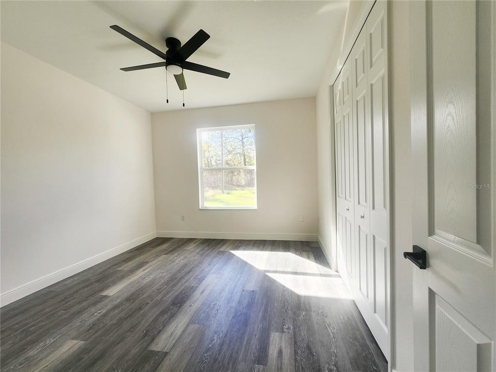 9483 Southwest 121st Terrace Dunnellon, FL 34432 - Photo 23 of 42 wooden floor in an empty room with a window