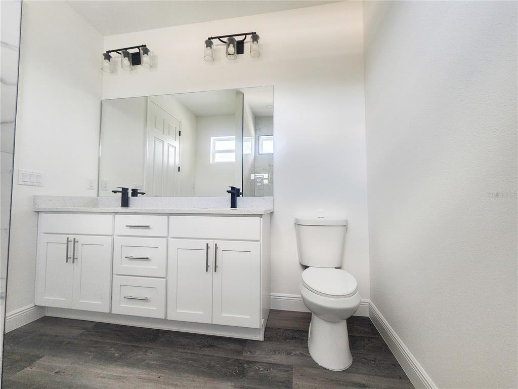 9483 Southwest 121st Terrace Dunnellon, FL 34432 - Photo 28 of 42 a bathroom with a toilet sink and mirror