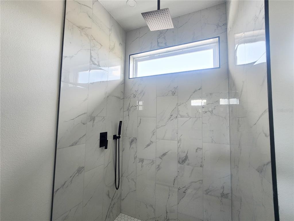 9483 Southwest 121st Terrace Dunnellon, FL 34432 - Photo 30 of 42 a bathroom with a glass shower door