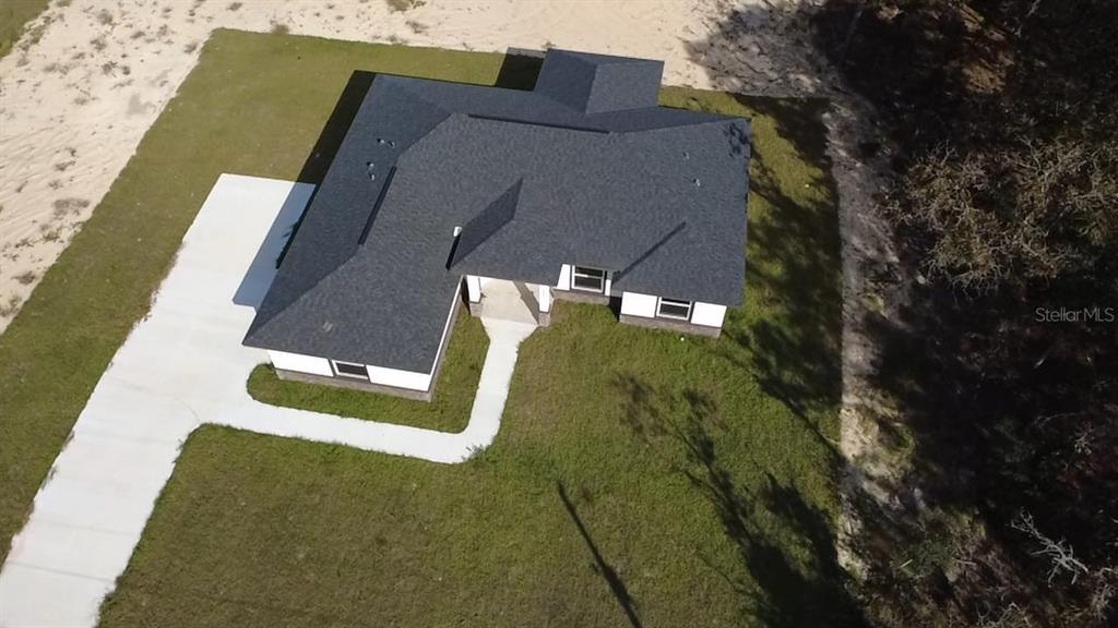 9483 Southwest 121st Terrace Dunnellon, FL 34432 - Photo 39 of 42 an aerial view of a house with a yard