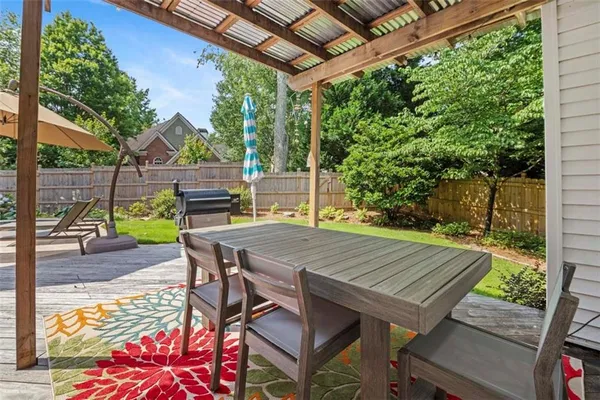 a view of a patio with table and chairs and wooden floor
