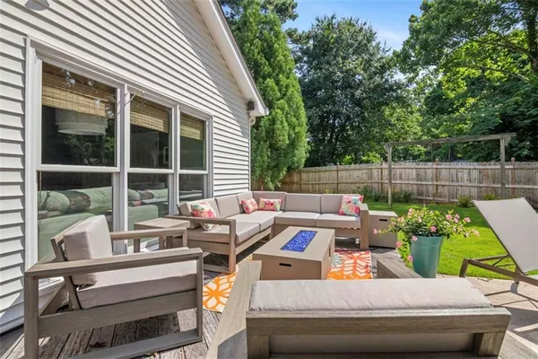 a view of backyard with outdoor seating and green space