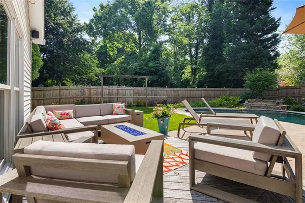 a view of a patio with couches chairs and a fire pit