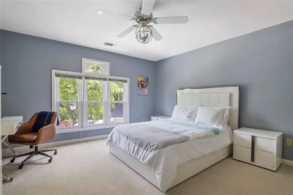 a bedroom with a bed and a chair