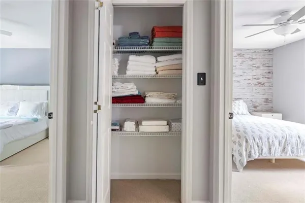 a view of a bedroom with a bed and the view of bathroom