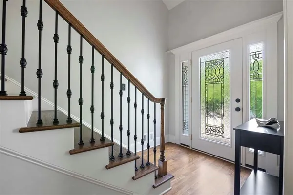 a view of an entryway with wooden floor and door
