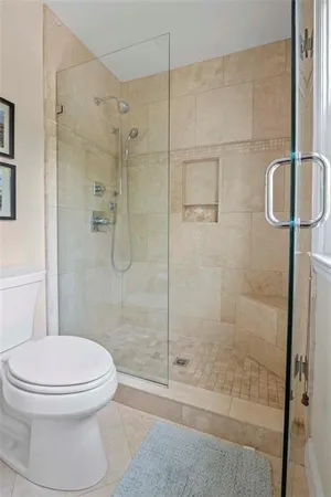 a bathroom with a toilet and a shower