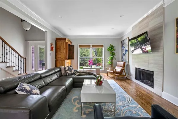 a living room with furniture fireplace and flat screen tv