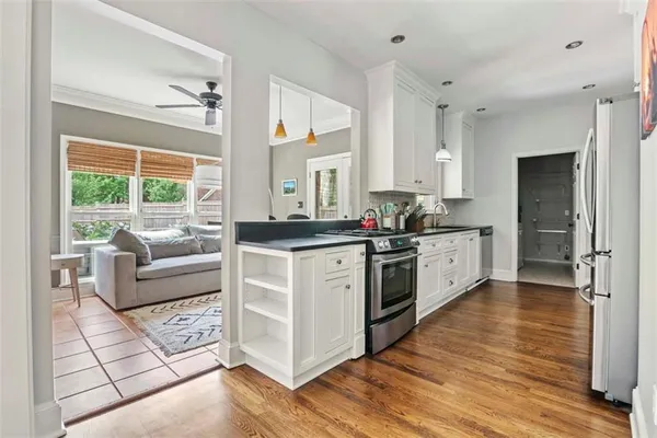 a kitchen with stainless steel appliances granite countertop a stove a sink and a refrigerator