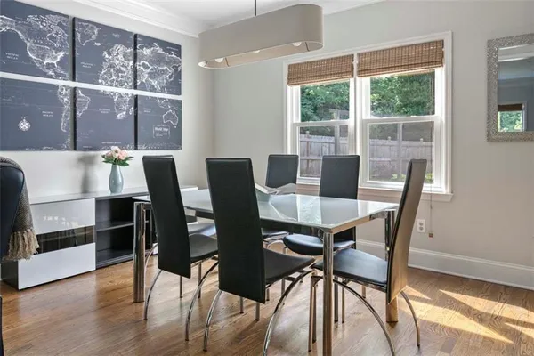 a view of a dining room with furniture window and wooden floor
