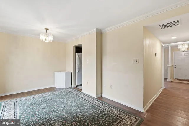 a view of a bedroom with wooden floor and a ceiling fan