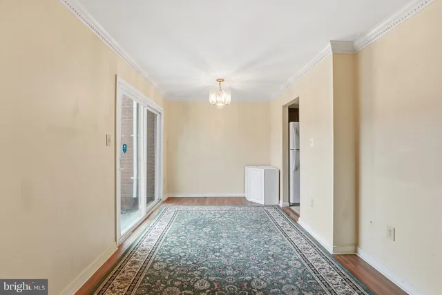 a view of hallway with closet and wooden floor