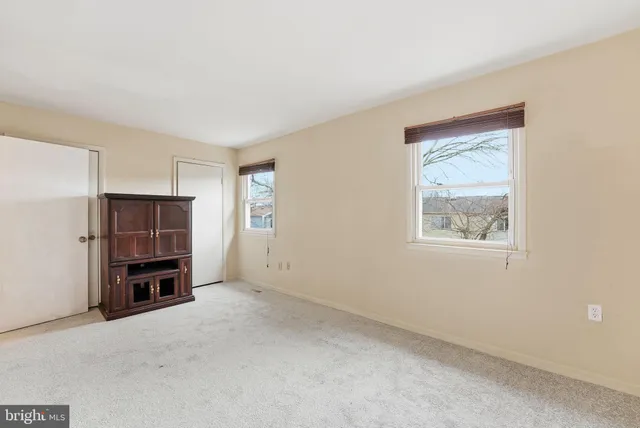 an empty room with furniture and window
