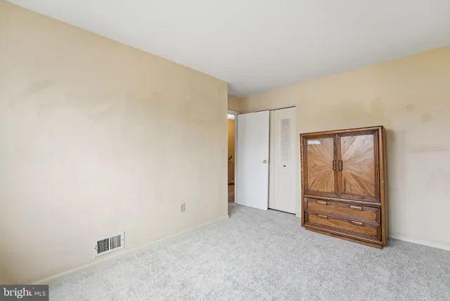 a view of an empty room and cabinet