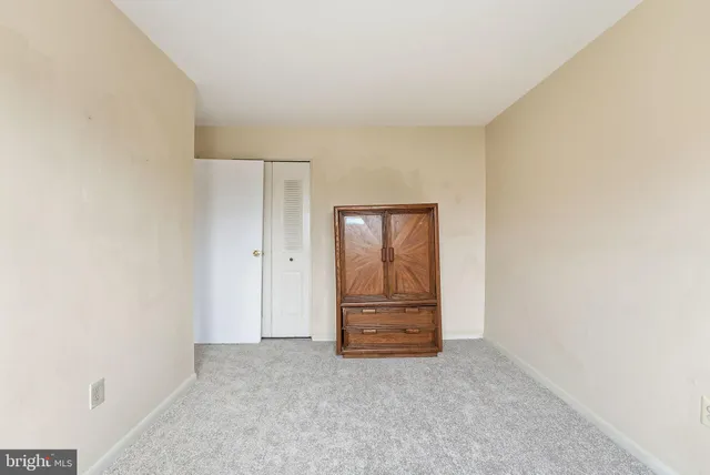a view of an empty room and fire place