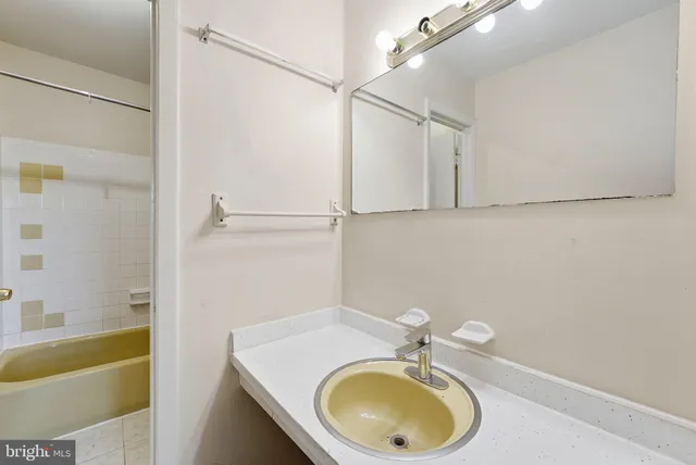 a bathroom with a sink a bathtub and a shower