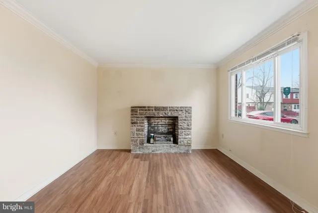 wooden floor in an empty room with a window