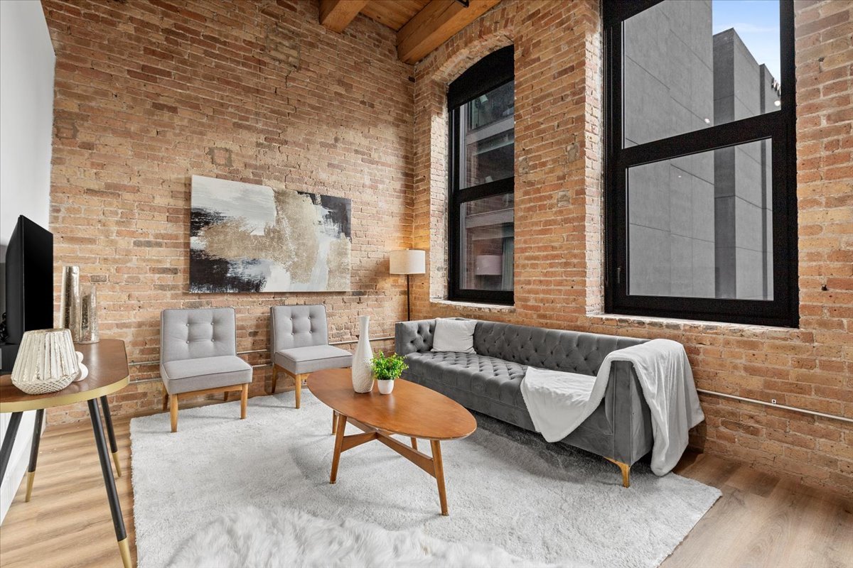 153 West Ohio Street, Unit 204 Chicago, IL 60654 - Photo 2 of 15 a living room with furniture and a flat screen tv