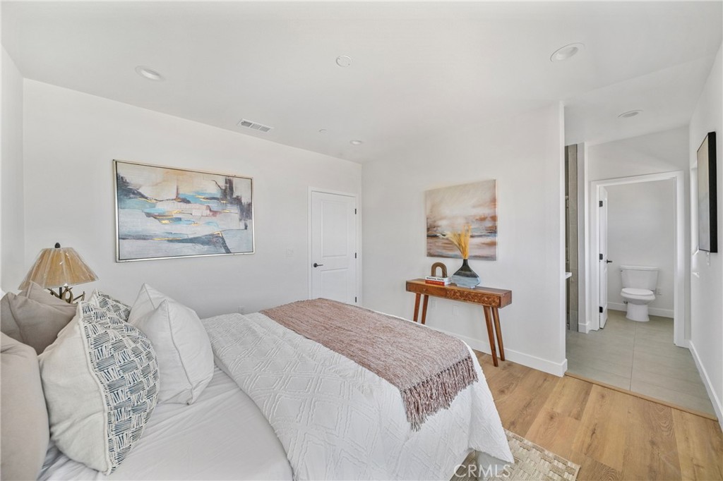 7692 9th Street, Unit 116 Buena Park, CA 90621 - Photo 10 of 13 a bedroom with a large bed and a chandelier