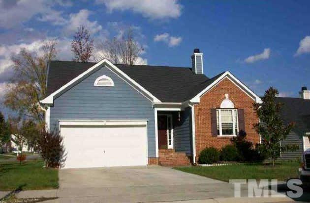 4601 Drewbridge Way Raleigh, NC 27604 - Photo 1 of 25 a front view of a house with a yard and garage