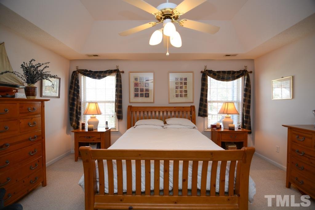 4601 Drewbridge Way Raleigh, NC 27604 - Photo 12 of 25 a bedroom with a bed a window and dresser