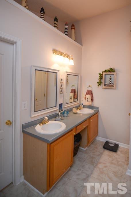 4601 Drewbridge Way Raleigh, NC 27604 - Photo 15 of 25 a bathroom with a granite countertop sink and a mirror