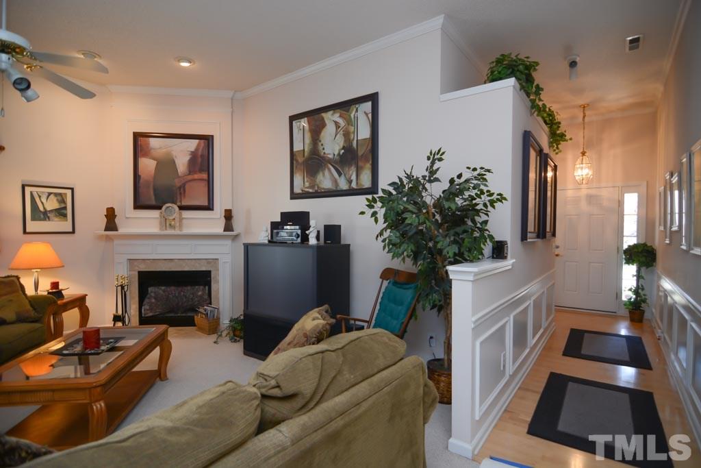4601 Drewbridge Way Raleigh, NC 27604 - Photo 22 of 25 a living room with furniture and a fireplace
