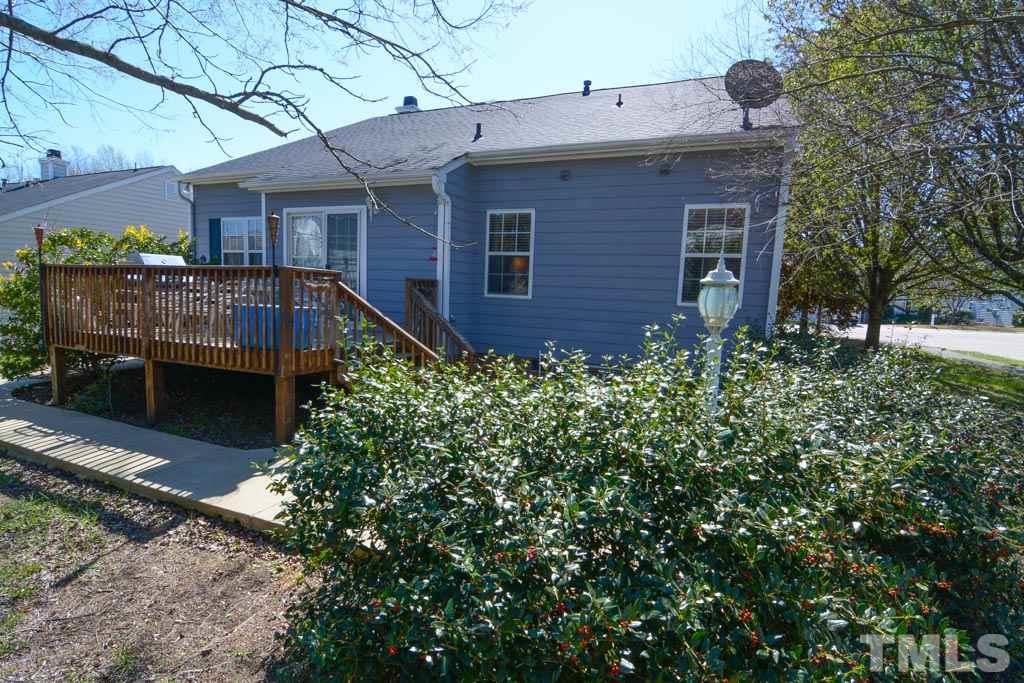 4601 Drewbridge Way Raleigh, NC 27604 - Photo 4 of 25 a view of a house with brick walls and a yard