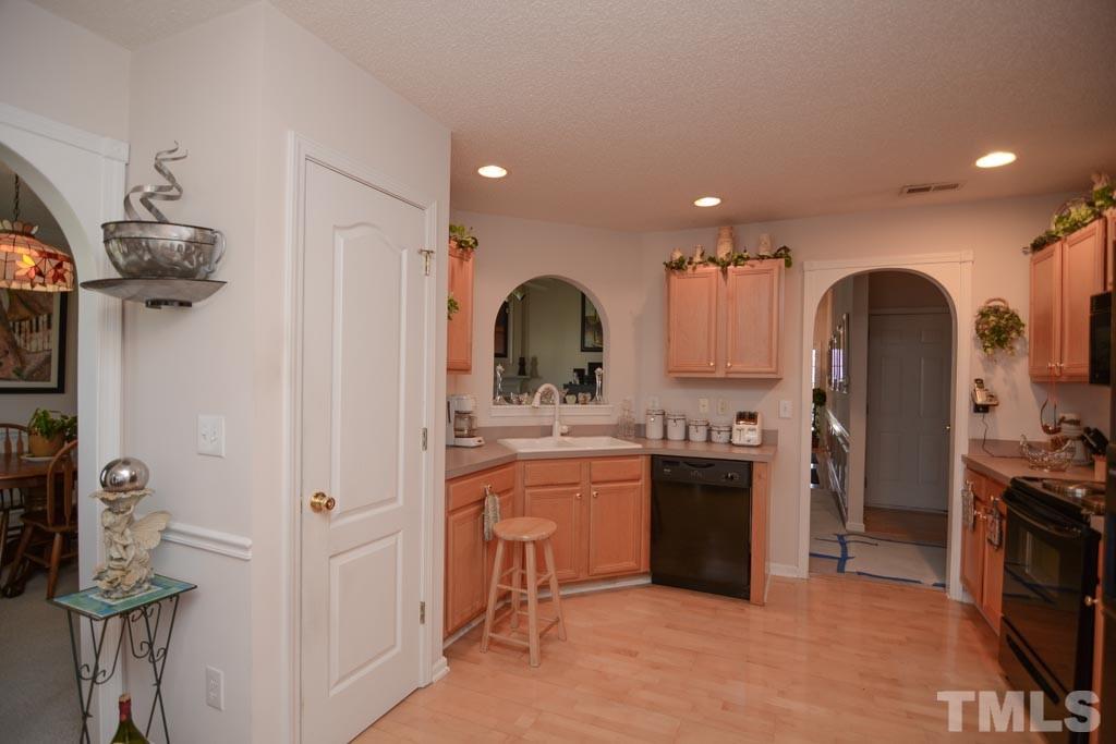 4601 Drewbridge Way Raleigh, NC 27604 - Photo 9 of 25 a kitchen with stainless steel appliances granite countertop a refrigerator and a stove top oven