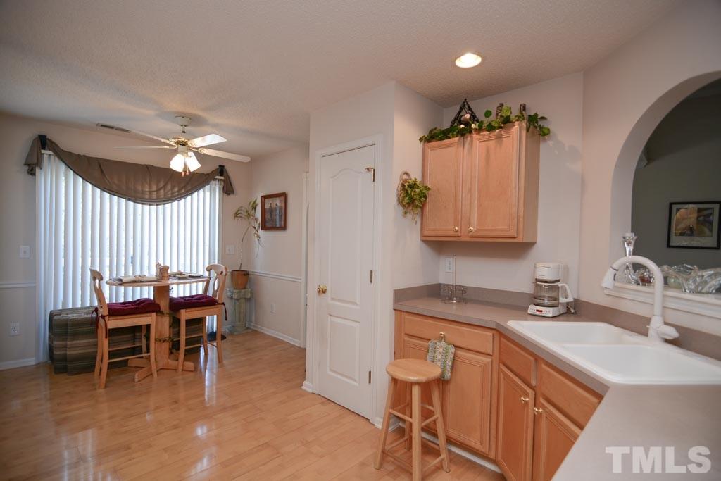 4601 Drewbridge Way Raleigh, NC 27604 - Photo 10 of 25 a view of a kitchen area with furniture and chandelier