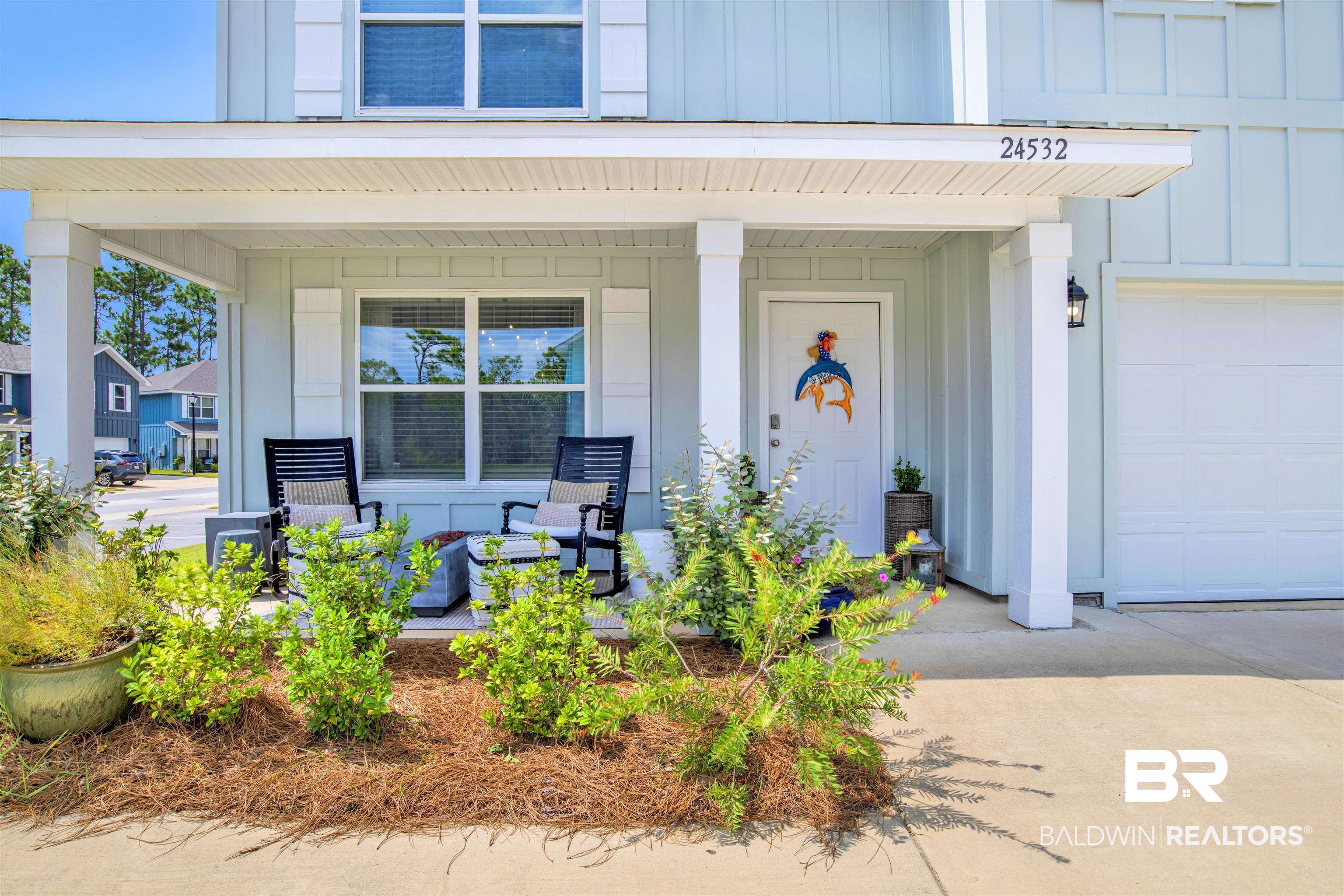 24532 Broken Sound Loop Orange Beach, AL 36561 - Photo 3 of 29 View of exterior entry featuring a porch and a garage