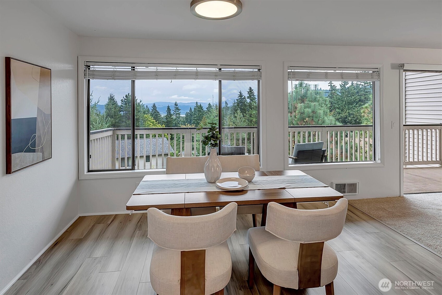 3410 161st Court Southeast, Unit 31 Bellevue, WA 98008 - Photo 12 of 25 a view of a dining room with furniture large windows and wooden floor
