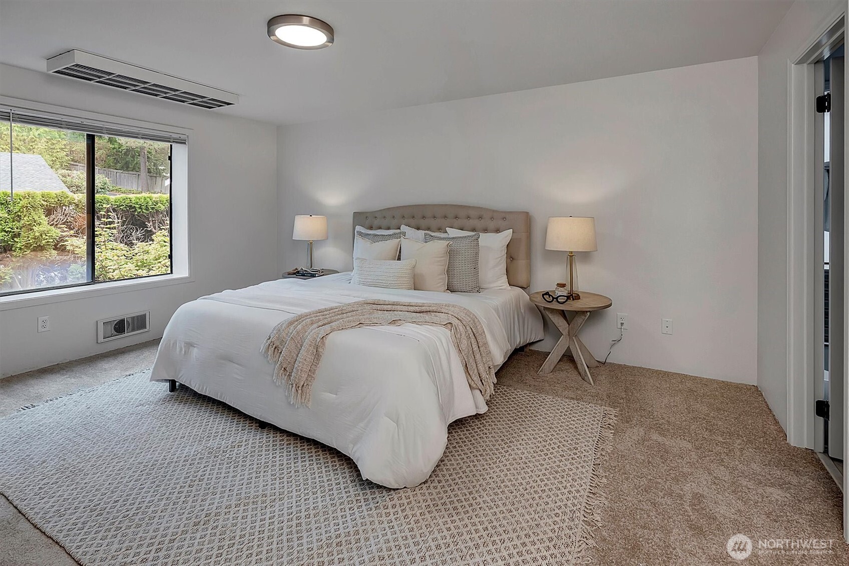 3410 161st Court Southeast, Unit 31 Bellevue, WA 98008 - Photo 14 of 25 a bedroom with a bed and a large window