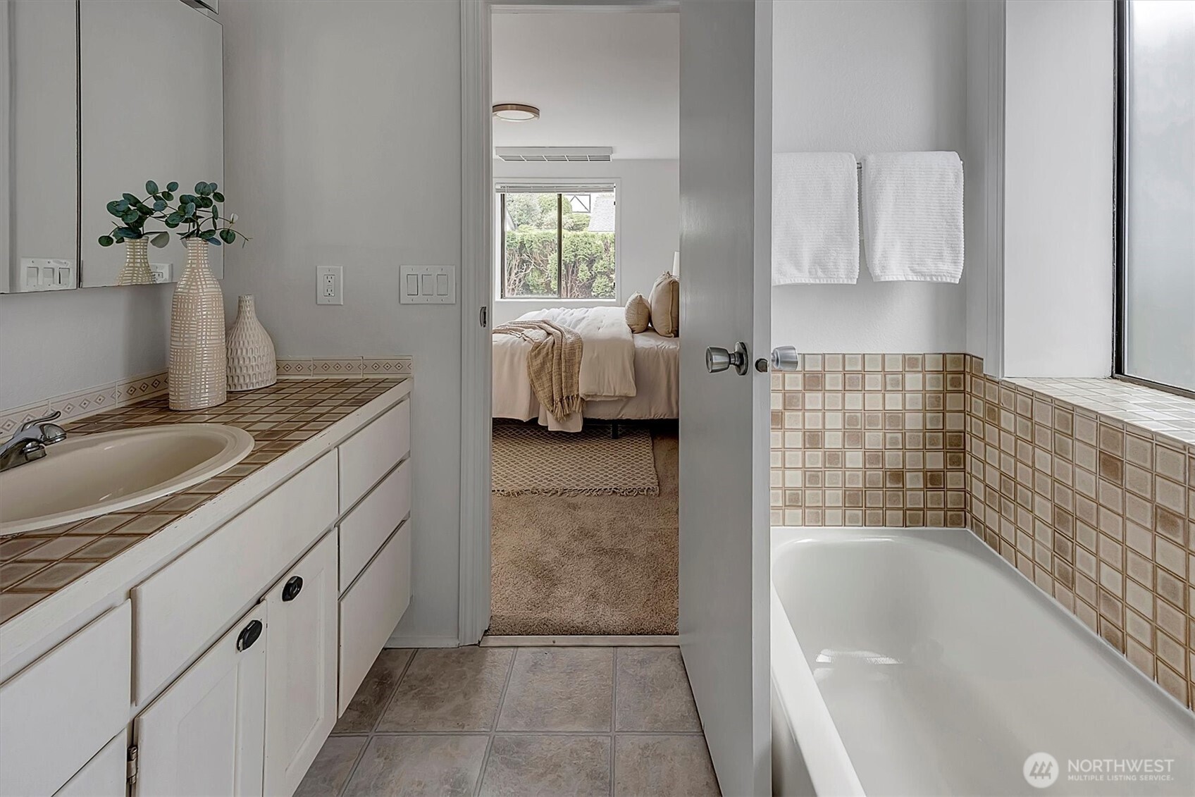 3410 161st Court Southeast, Unit 31 Bellevue, WA 98008 - Photo 17 of 25 a en suite bathroom with a granite countertop tub and a sink
