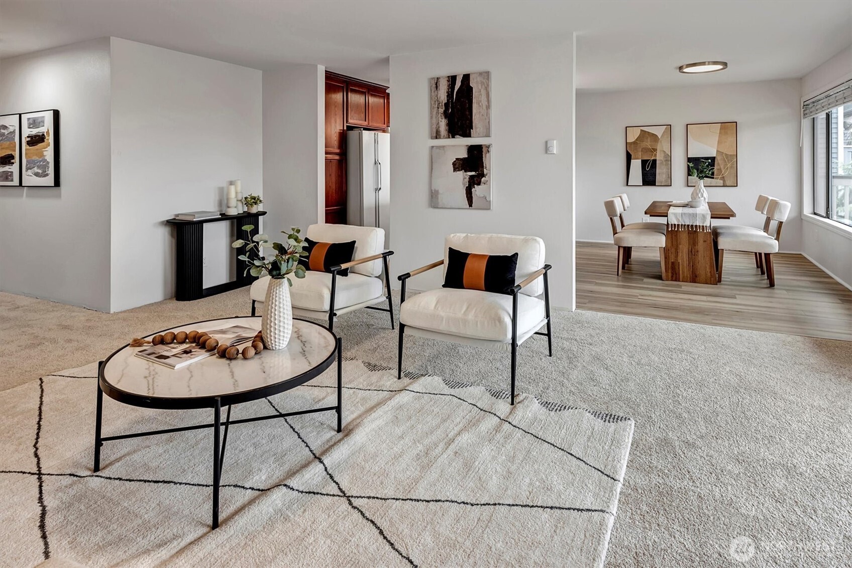 3410 161st Court Southeast, Unit 31 Bellevue, WA 98008 - Photo 5 of 25 a living room with furniture a rug and wall paintings