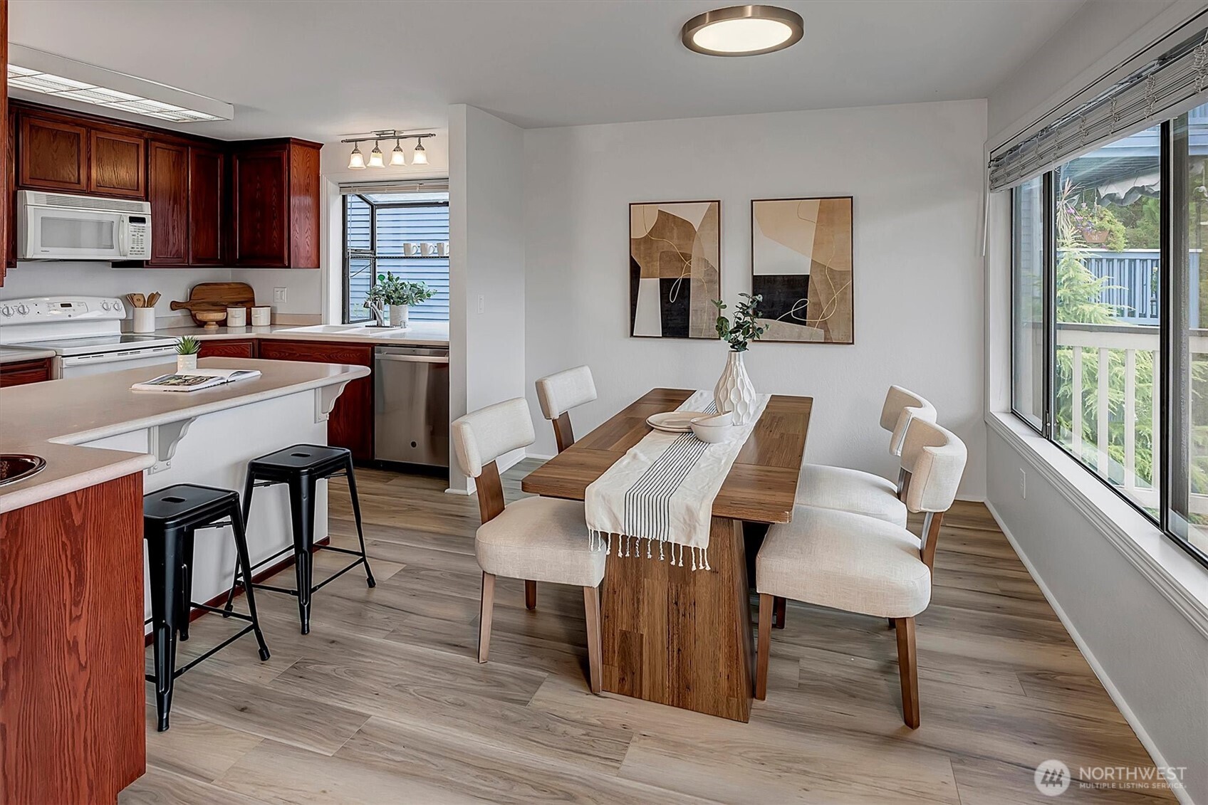 3410 161st Court Southeast, Unit 31 Bellevue, WA 98008 - Photo 8 of 25 a view of a dining room with furniture and wooden floor