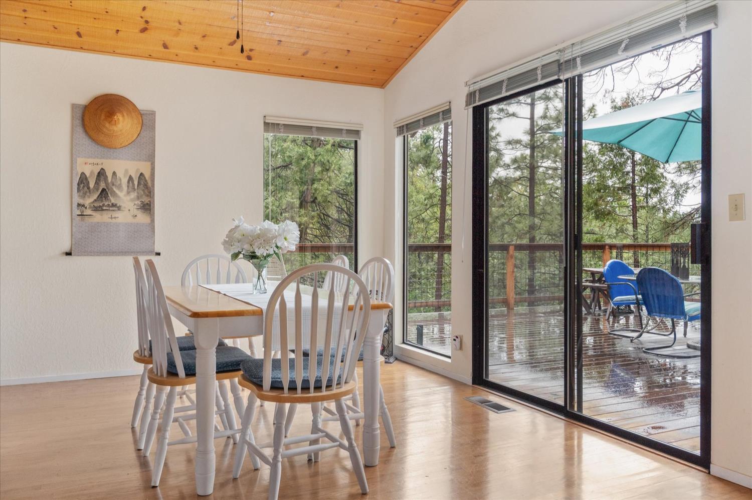 596 Sugarbush Lane Murphys, CA 95247 - Photo 18 of 48 a view of a dining room with furniture and a floor to ceiling window