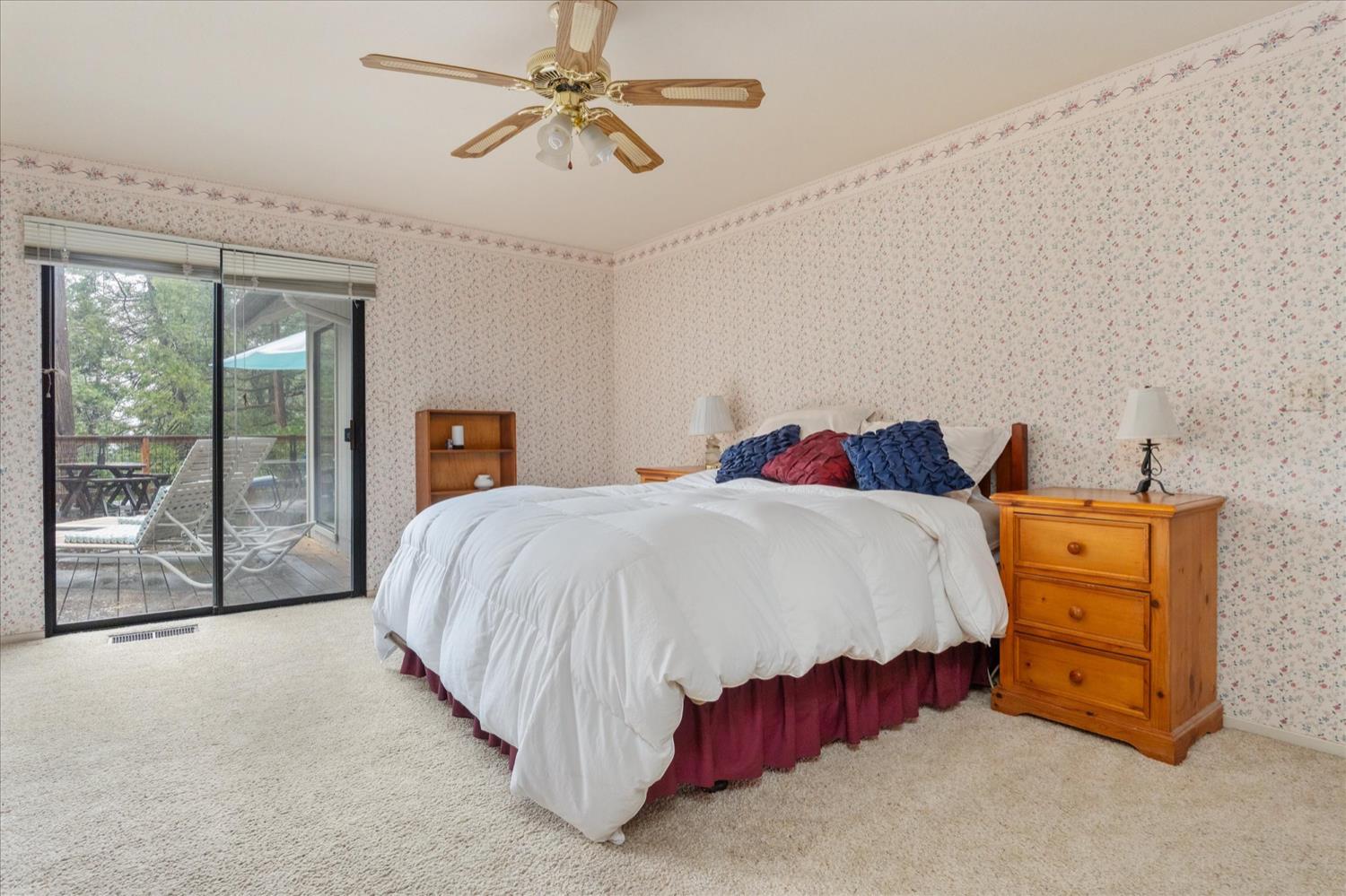 596 Sugarbush Lane Murphys, CA 95247 - Photo 23 of 48 a spacious bedroom with a bed and a chandelier