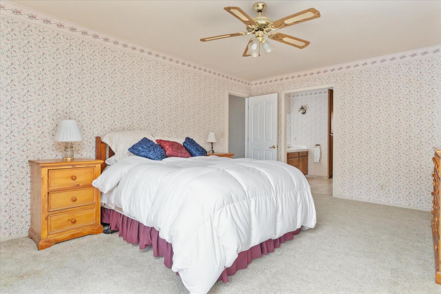 596 Sugarbush Lane Murphys, CA 95247 - Photo 25 of 48 a bedroom with a bed and a chandelier