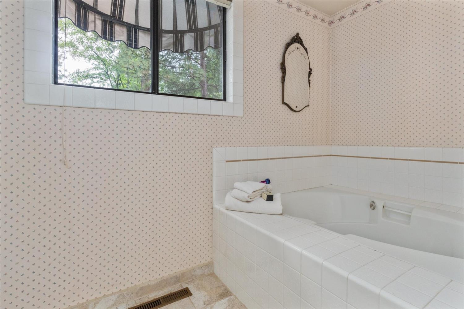 596 Sugarbush Lane Murphys, CA 95247 - Photo 27 of 48 a bathroom with a bath tub with a shower