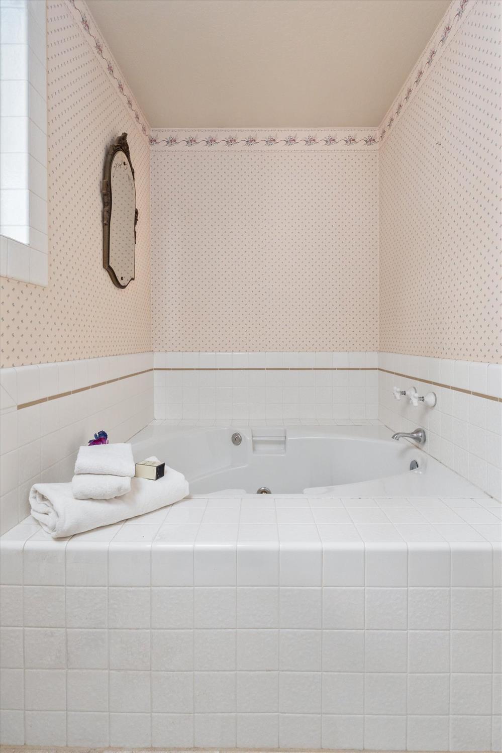 596 Sugarbush Lane Murphys, CA 95247 - Photo 28 of 48 a bathroom with a tub sink and vanity