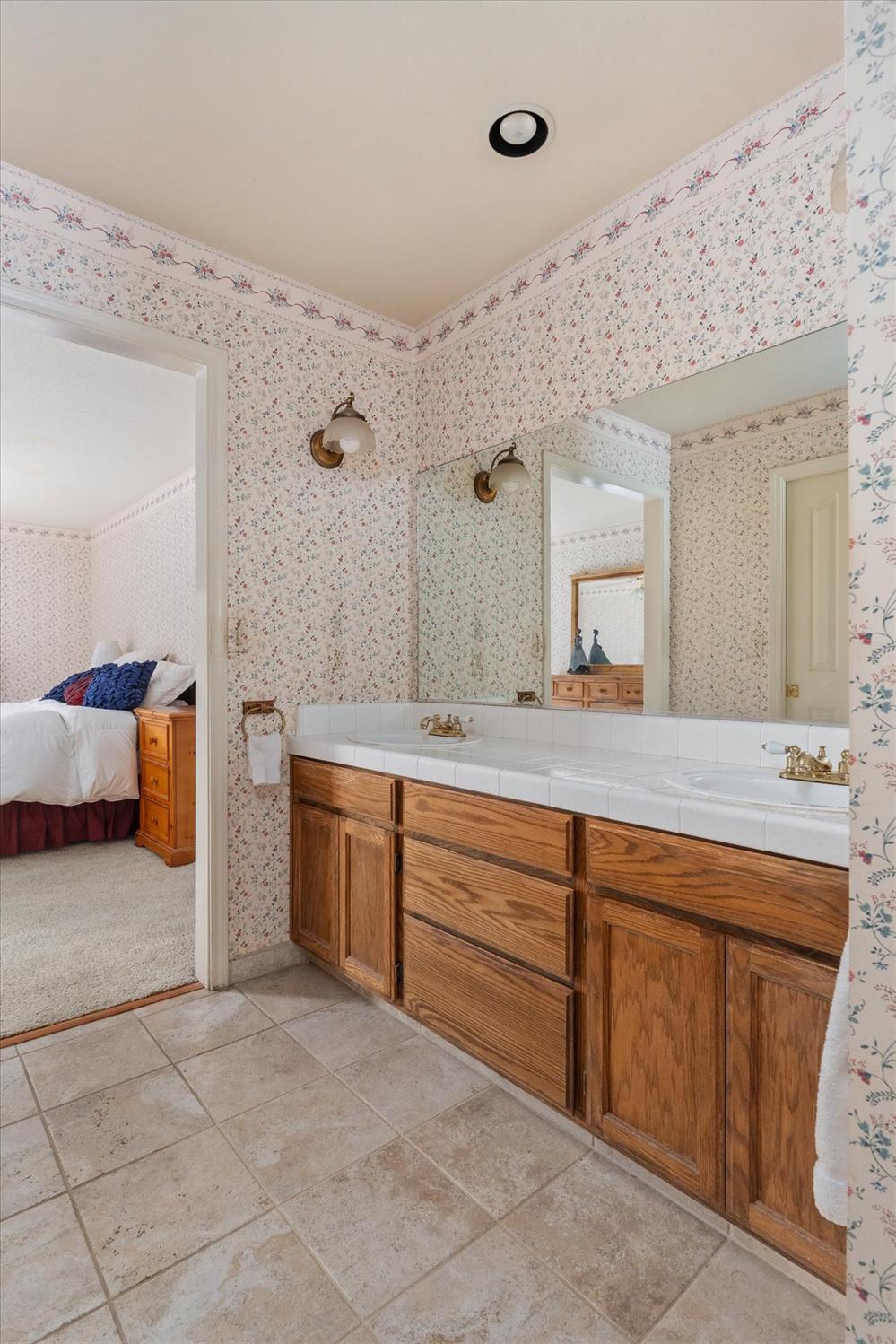 596 Sugarbush Lane Murphys, CA 95247 - Photo 30 of 48 a spacious bathroom with a granite countertop sink and a mirror