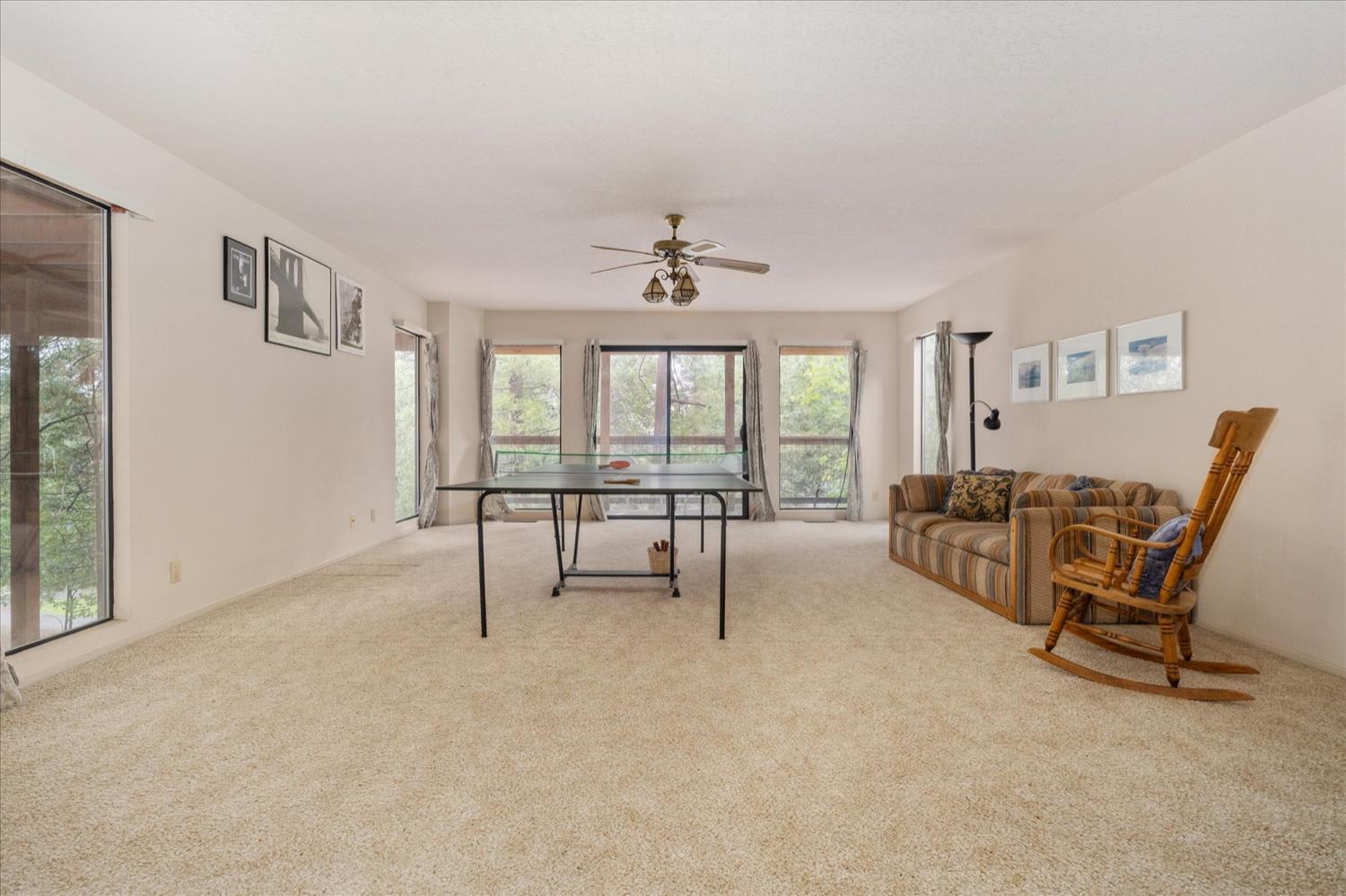 596 Sugarbush Lane Murphys, CA 95247 - Photo 36 of 48 a living room with furniture and a floor to ceiling window