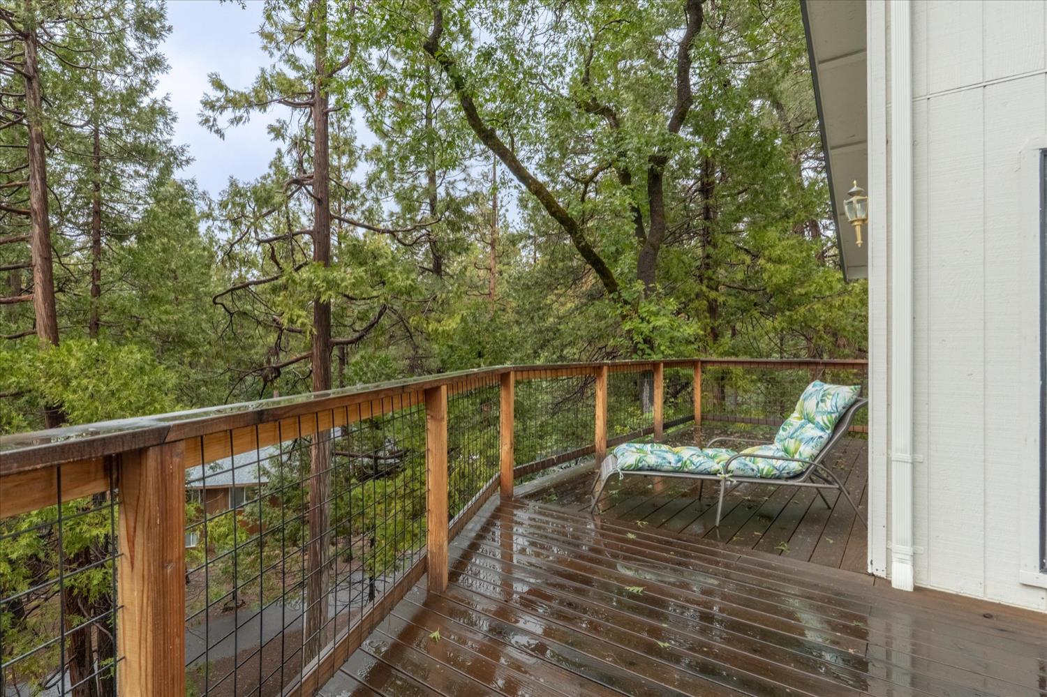 596 Sugarbush Lane Murphys, CA 95247 - Photo 41 of 48 a view of a balcony with wooden chairs and floor